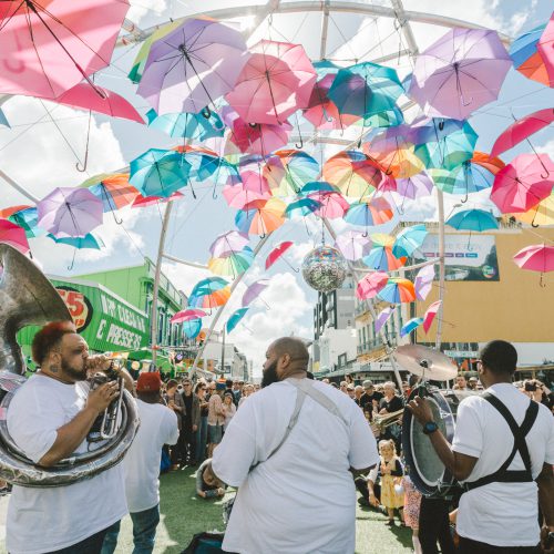 Four part brass band playing under the overstreet umbrella installation