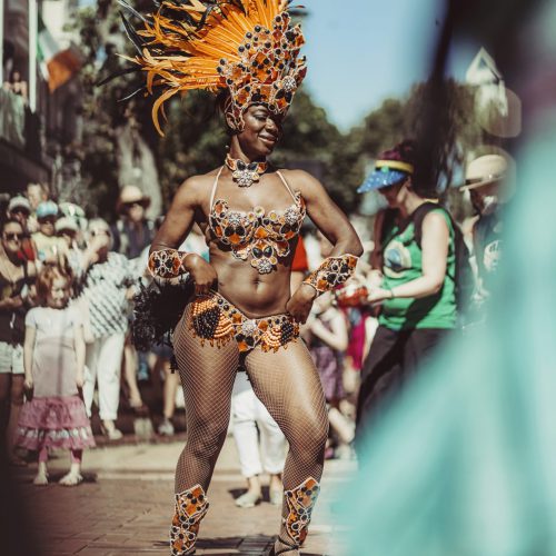 Batucada dancer performing in a sunny street