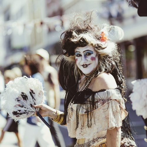 Woman dressed as pirate smiling at the camera, with a man dressed as a pirate next to her