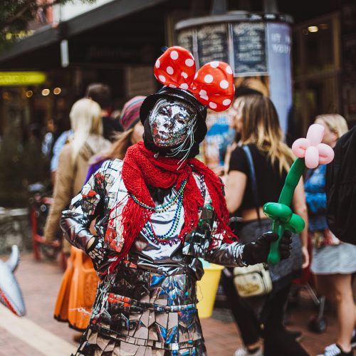 Street theatre performer in a costume made of mirrors, with buddy ears