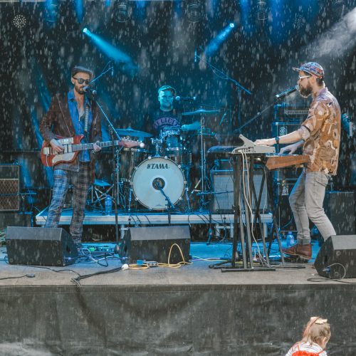 Band performing on stage in the rain