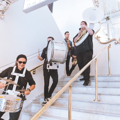 Marching band parading down Opera House steps