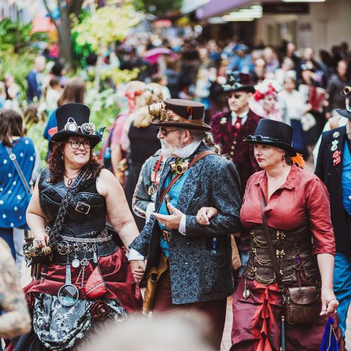 A collection of people dressed in steam punk costumes