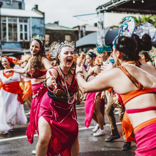 A Batucada group smiling and dancing in the Swan Carpark