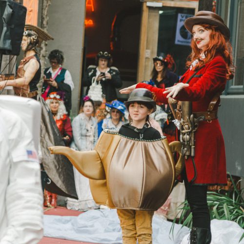 Street theatre, steam punk mum with a small child dressed as a teapot