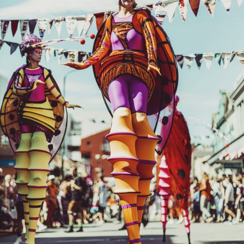 Towering Walking Creatures in colourful costume